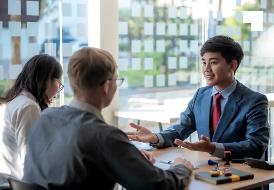 Asian business consultant presenting ESG strategy to clients during corporate advisory meeting