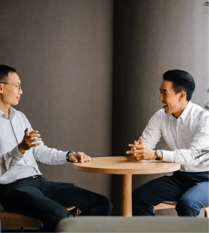 Two businessmen chatting at a table