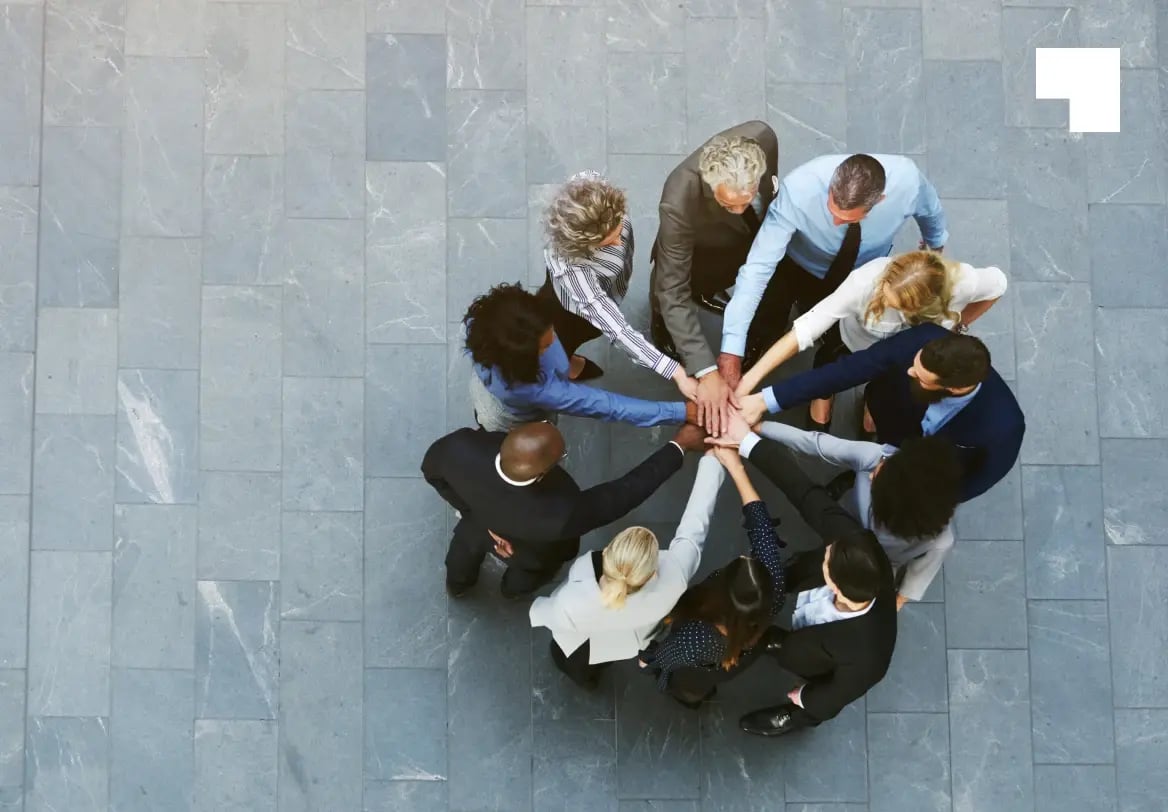 Diverse business team stacking hands together symbolizing company formation partnership and collaboration