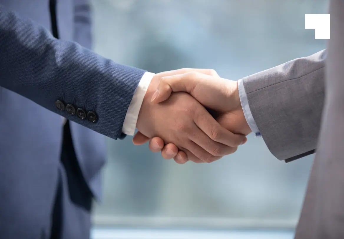 Two business professionals shaking hands to formalize nominee shareholder agreement