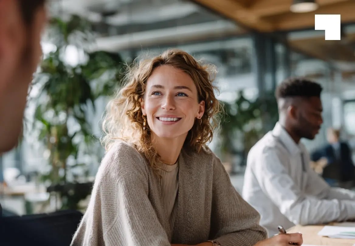Professional woman smiling during private trust company consultation in modern office setting