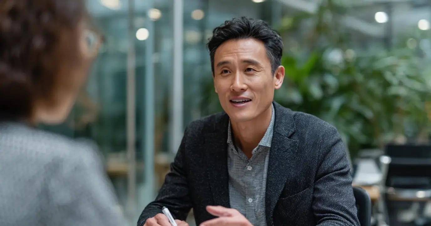 Asian businessman in business casual attire engaged in professional consultation at modern office
