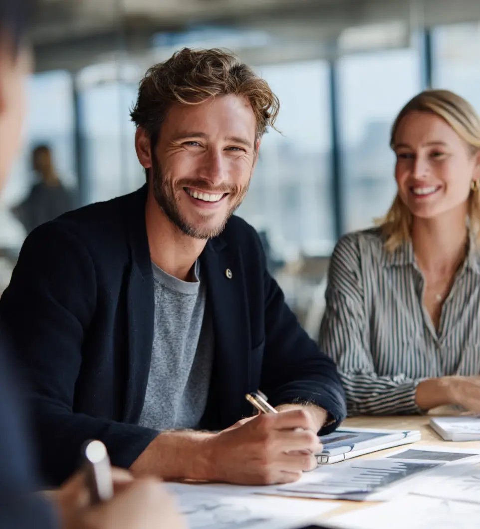 Business professionals reviewing and signing fund service documents at meeting table