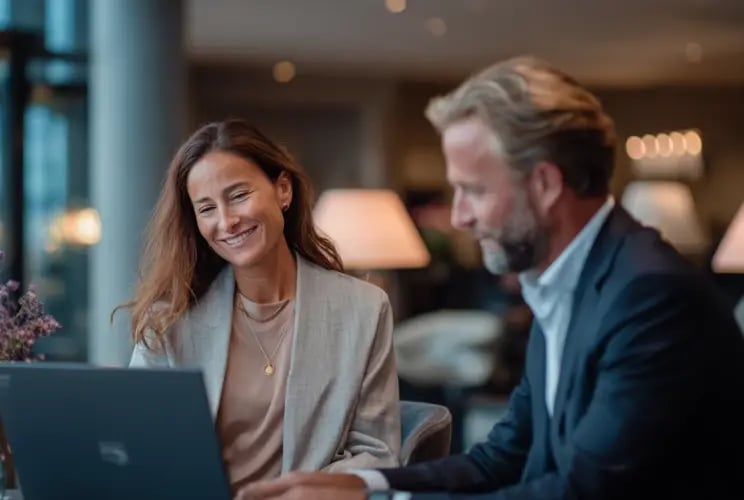 Two business professionals reviewing laptop during economic substance compliance consultation