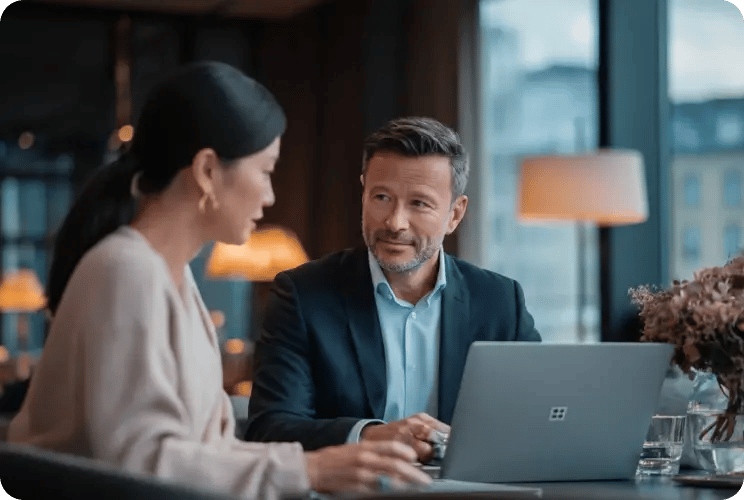 Business professionals in meeting discussing corporate services with laptop in modern office