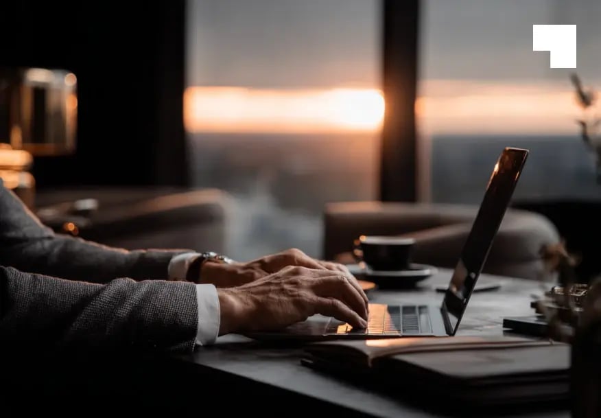 Professional working on laptop in modern office with secure document management services