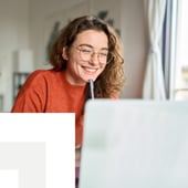 Remote worker smiling at laptop