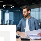 Businessman working on documents on computer