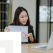 Businesswoman presenting a report on a laptop