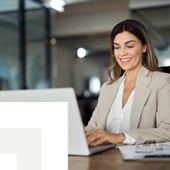 Smiling professional working on a laptop