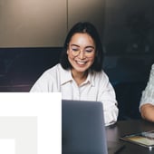 Business woman smiling at a laptop