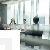 Business meeting in a glass-walled room
