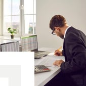 Businessman calculating on desk
