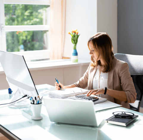 Businesswoman calculating at desk