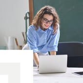 Young woman working on a laptop at a desk