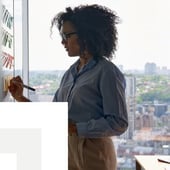 Businesswoman writing on a board