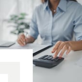 Businesswoman using calculator