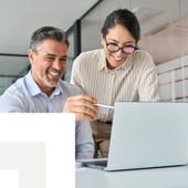 Two business people viewing a laptop