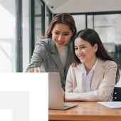 two women working on a laptop