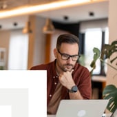Businessman concentrating looking at a laptop