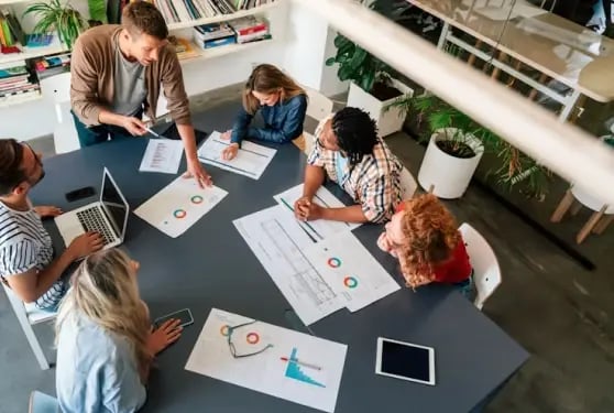 Diverse business team collaborating on economic substance compliance strategy with charts and documents